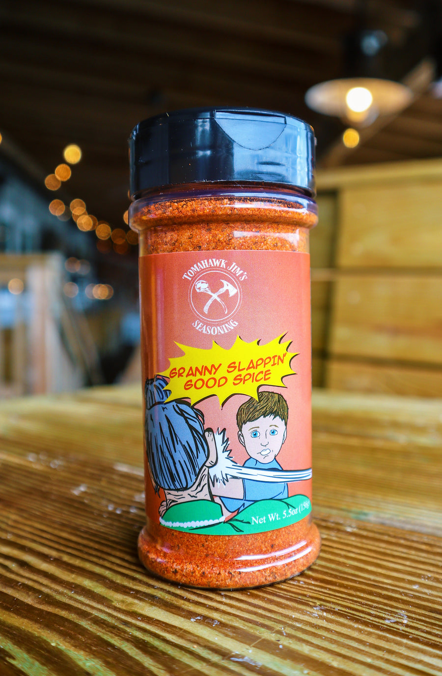 Spice jar with colorful label on a wooden surface