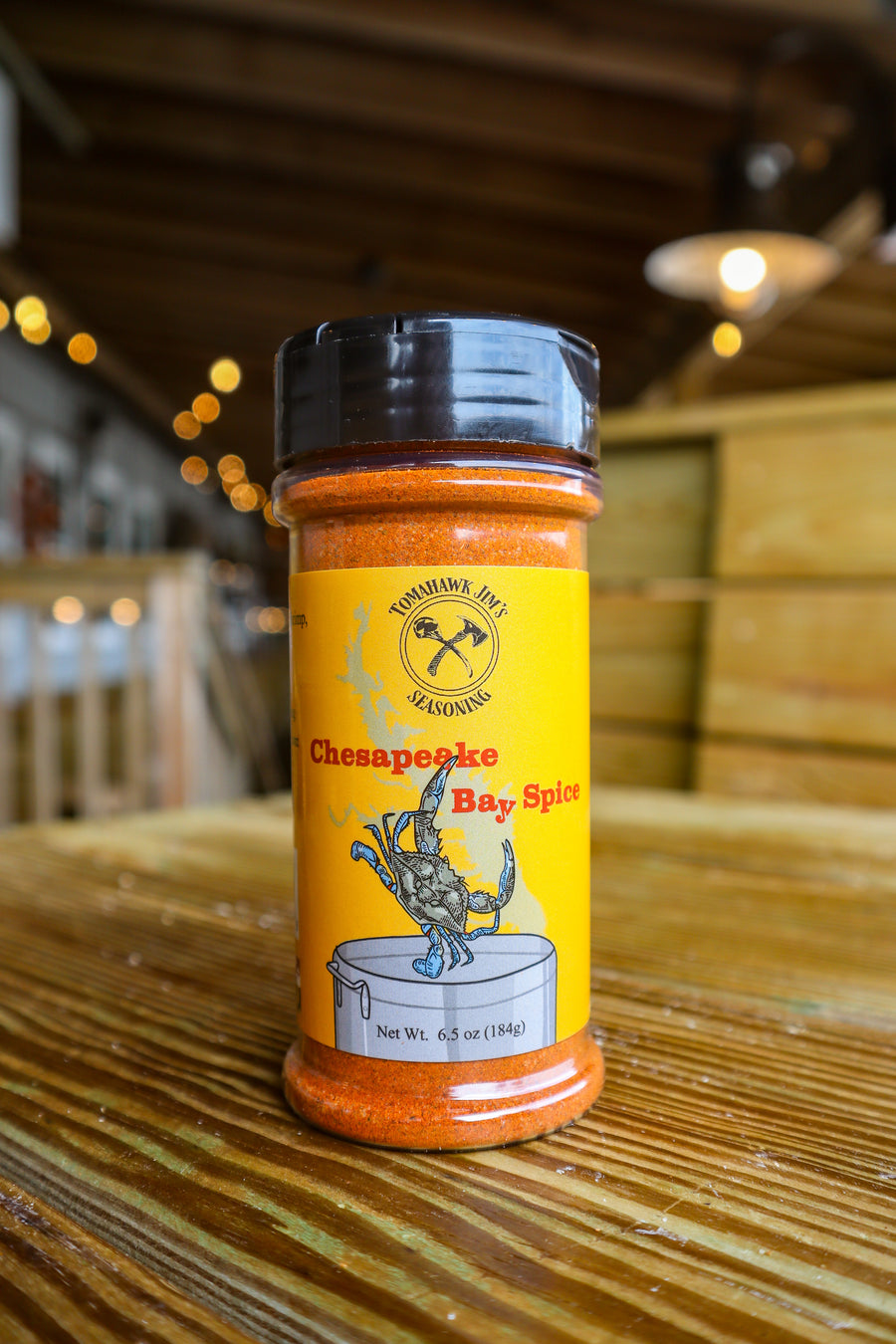 Chesapeake Bay Spice seasoning bottle on a wooden surface with blurred background